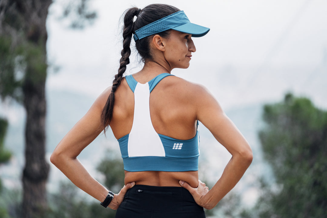 woman in cep visor and cep sports bra
